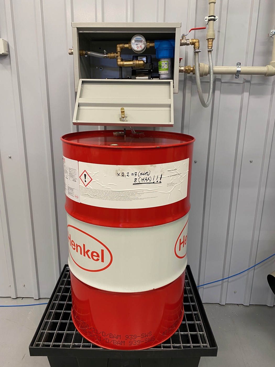 Hydroblend cabinet installed above a Henkel Bonderite concentrate barrel in a real workshop